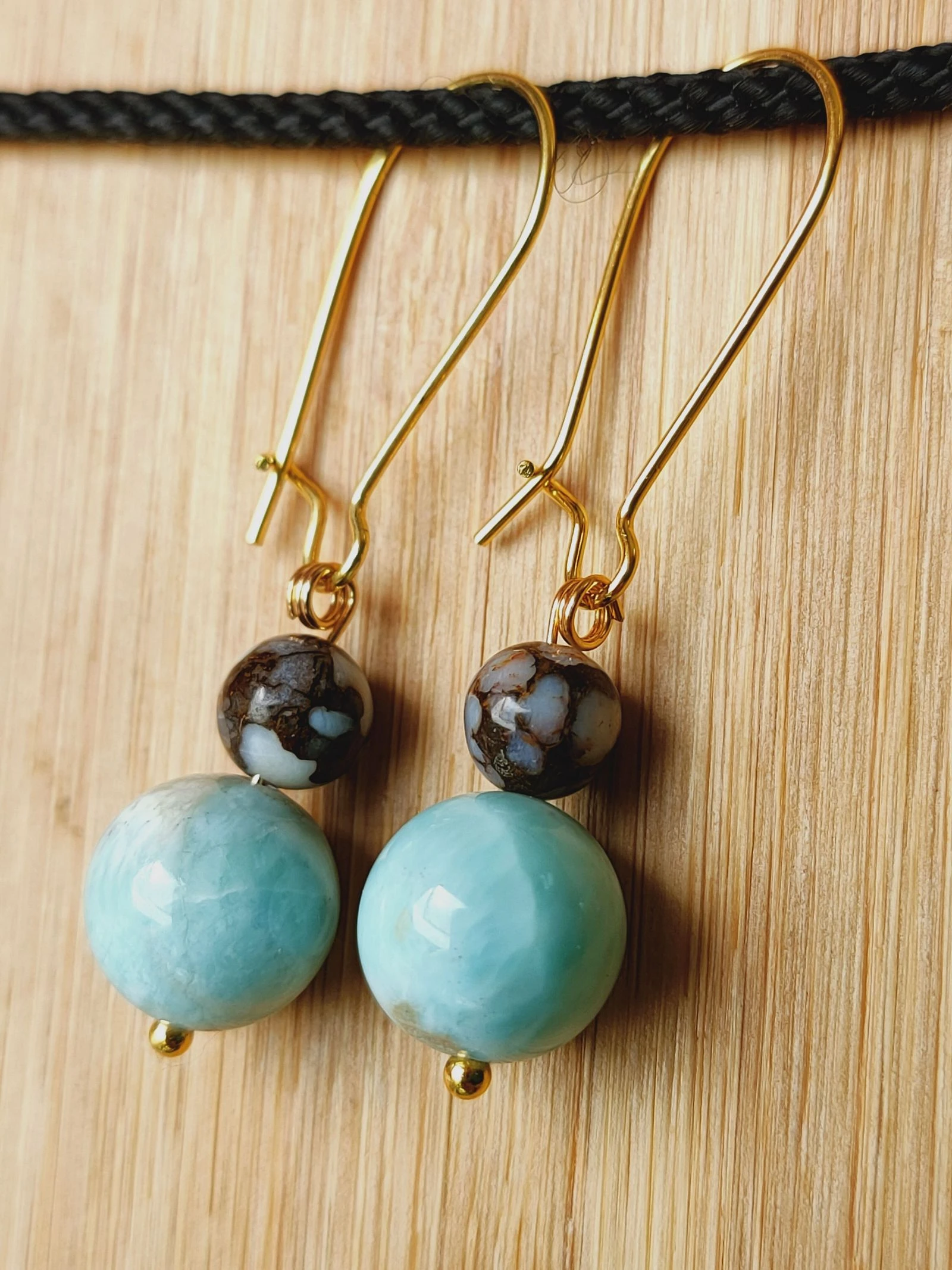 Une paire de boucles d'oreilles en Larimar et opale brune